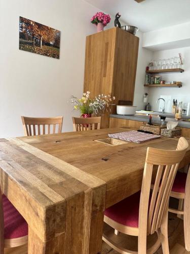 a large wooden table in a kitchen with chairs at Hotel U Kabinky in Janske Lazne