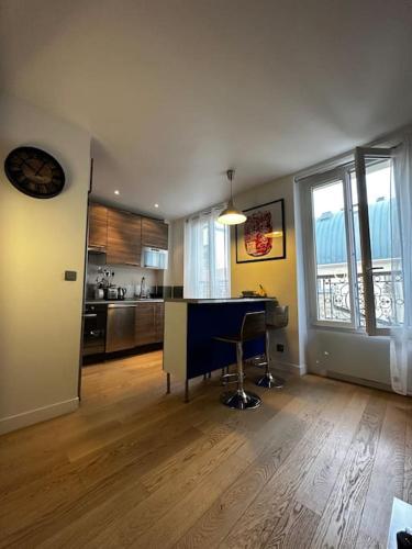 a kitchen with a desk in the middle of a room at Charmant Appartement en Coeur de Ville in Puteaux