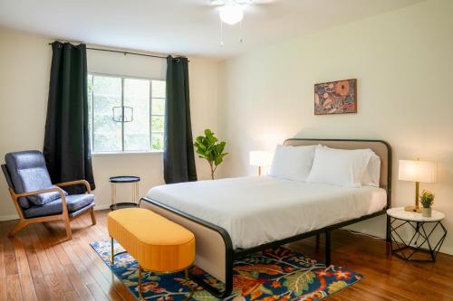 a bedroom with a bed and a chair and a window at Los Angeles Miracle Mile Spacious 2BR Townhouse in Los Angeles
