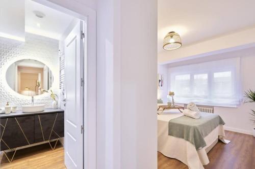 a bathroom with a table and a sink and a mirror at El Balcón de Jauregui centro in Salamanca