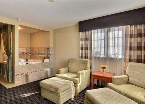a living room with a couch and a chair at Clarion Inn Renton-Seattle in Renton
