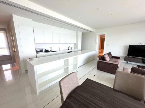 a large living room with a couch and a kitchen at Del Mar Beachfront 3 Bedroom 'A' Residence in Limassol