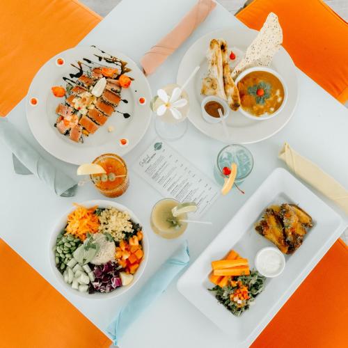 a table with plates of food on it at Holiday Inn Resort Grand Cayman by IHG in George Town