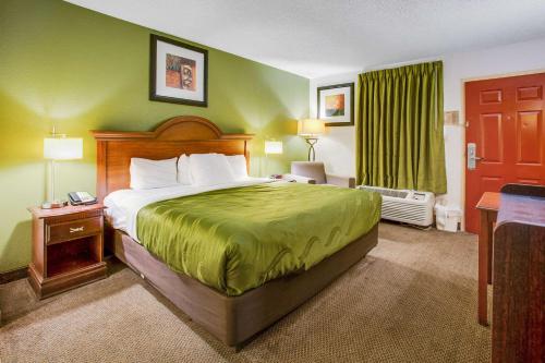 a hotel room with a bed and a window at Quality Inn Fort Campbell-Oak Grove in Oak Grove