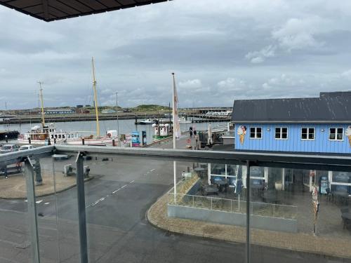 a view of a marina with a blue building at Hvide Sande Hotel in Hvide Sande