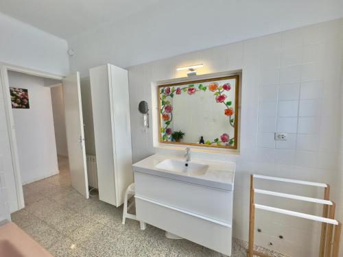 a bathroom with a sink and a mirror on the wall at Casita Bouganvilla in Roses