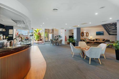 a lobby with chairs and a bar in a hotel at Comfort Resort Waters Edge in Port Macquarie