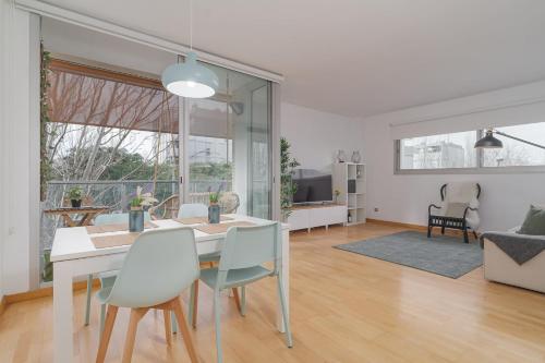 a dining room and living room with a table and chairs at GuestReady - Sant Adrià de Besòs Hideaway in Barcelona