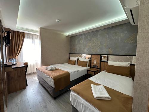 a hotel room with two beds and a window at Boutique Dedem Hotel Sultanahmet in Istanbul