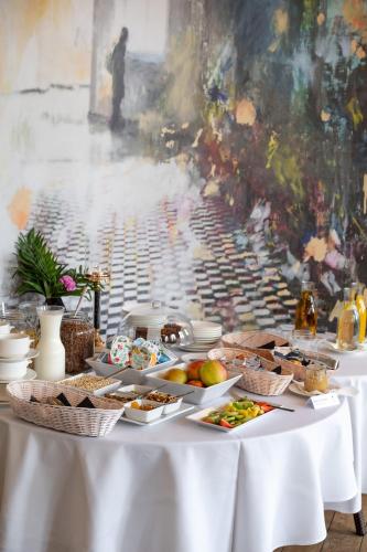 a table with plates of food on top of it at Hotel Wileński in Olsztyn