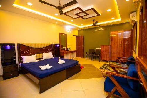 a bedroom with a bed with two towels on it at Queens Paradise Estate Resort in Puducherry