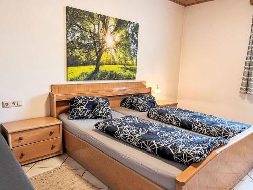 a bedroom with two beds and a painting on the wall at Holiday Home LuxuSölk-5 by Interhome in Stein an der Enns