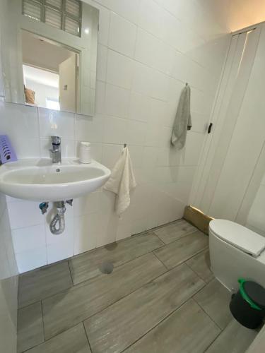 a bathroom with a sink and a toilet at Blife Faro Beach Hostel & Rooms in Faro