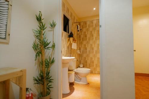 a bathroom with a toilet and a sink at Pallet Homes - Petalsville in Iloilo City
