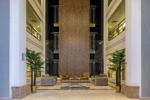 a lobby with a large column in a building at Hotel 21 Makkah in Makkah