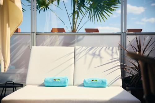 two blue pillows sitting on a bed in a room at Avalon Hotel in Gothenburg