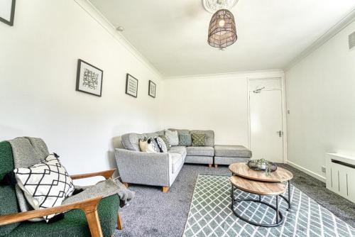 sala de estar con sofá y mesa en Guest Homes - Chester House Retreat en Kidderminster