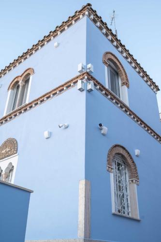 a blue and white church with a window at DIMORA BORDIN Luxury Aparthotel Animali ammessi in Nettuno