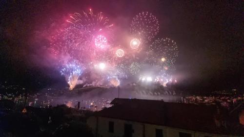 a firework display at night with a crowd of people at Comacina Villa in Como