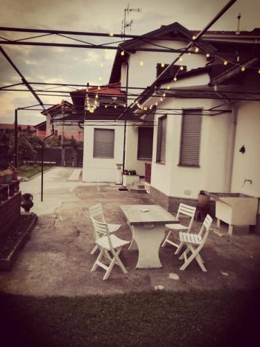 a patio with a table and chairs in front of a house at Casa Vacanze Terra di Mezzo in Invorio Inferiore