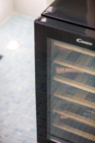 a refrigerator with its door open in a room at De President Suite, DeMaNi President Suites in Sitia