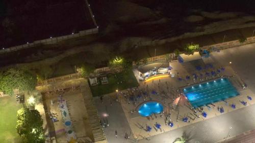 an overhead view of a swimming pool at night at نزل الشباب in Ţawd
