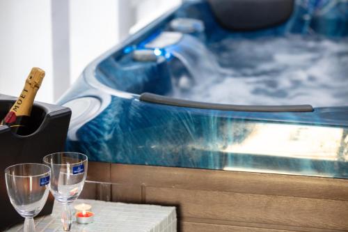 a table with two glasses and a bottle of wine at De President Suite, DeMaNi President Suites in Sitia