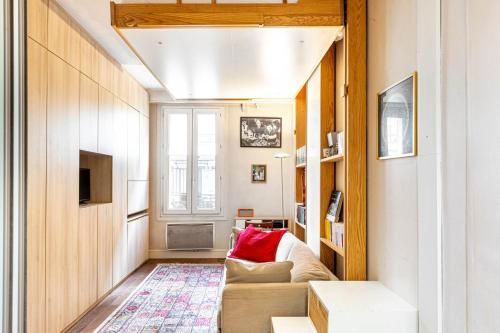 un salon avec un canapé et une télévision dans l'établissement GuestReady - Parisian retreat with a courtyard, à Paris