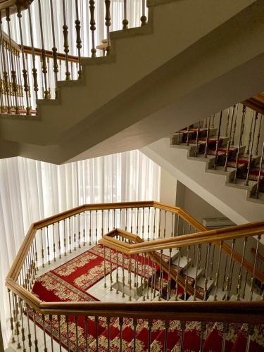 a room with stairs and a red rug on the floor at Natsionalny Hotel in Kyiv