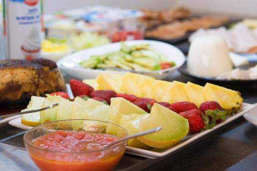 a tray of food with fruit on a table at Hotel Marfil in San Antonio