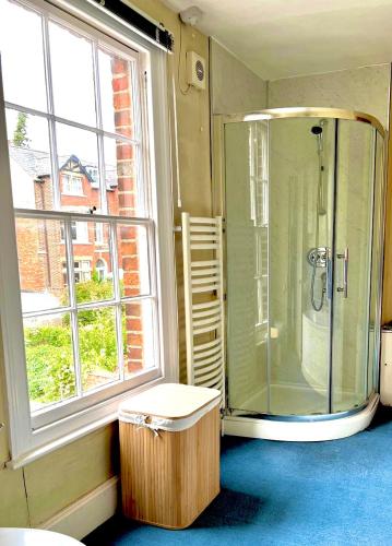 a bathroom with a shower and a window at Historic Manor house sleeps 10, free parking in Oxford