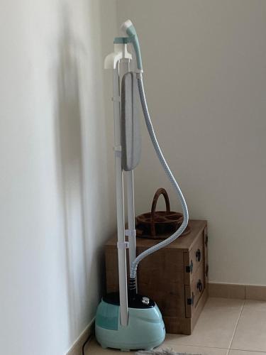 a blue vacuum cleaner sitting next to a box at The residences 1 - Luxury 1BR apt in Downtown Dubai - 2 mins walk to Burj Khalifa & Dubai Mall in Dubai