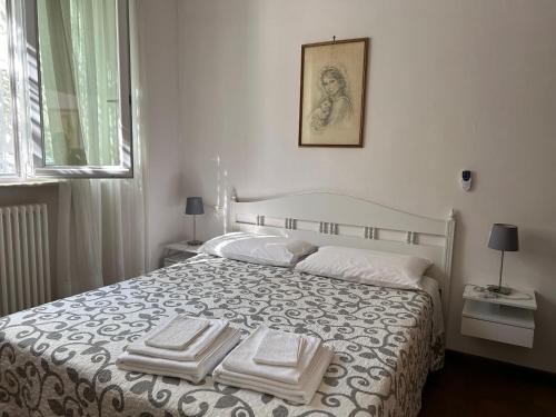 a bedroom with a bed with three towels on it at Casa vacanze Diana in Viareggio