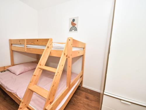 a bunk bed in a small room with a ladder at Holiday Home Marko by Interhome in Sukošan