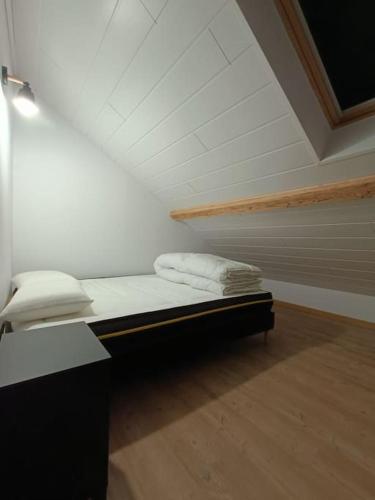 a room with a bed and a chair in a attic at # Le Beffroi# Maison# Murol in Murol