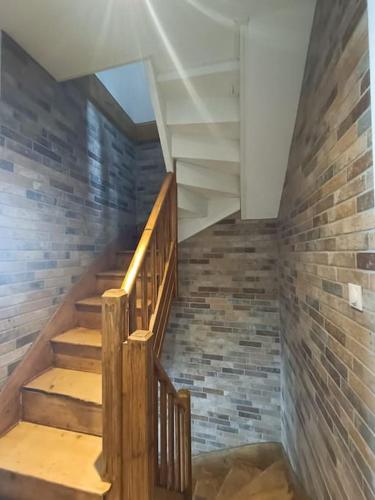a staircase in a room with a brick wall at # Le Beffroi# Maison# Murol in Murol