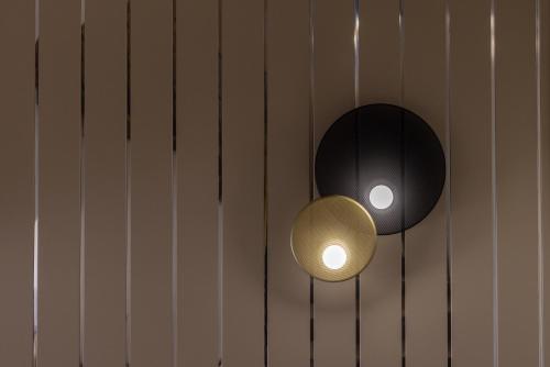 a couple of lights on the side of a wall at Brit Hotel Europ Bergerac in Bergerac