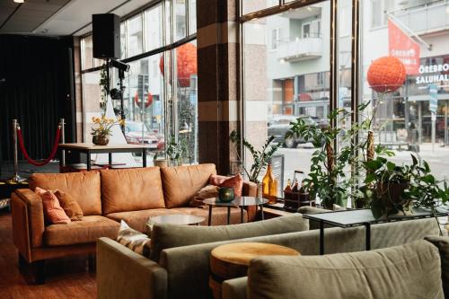 a living room with a couch and chairs at Clarion Hotel Örebro in Örebro