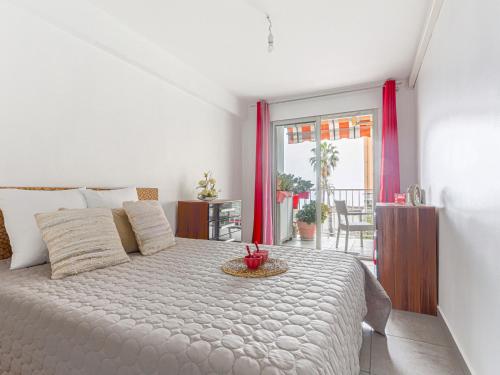 - une chambre avec un lit blanc et une table dans l'établissement Apartment Le Carina by Interhome, à Nice