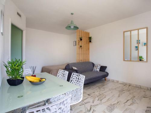 un salon avec une table, des chaises et un canapé dans l'établissement Studio le ponant by Interhome, à Saint-Laurent-du-Var