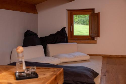 a room with two chairs and a table and a window at Aura Relais in Urbino