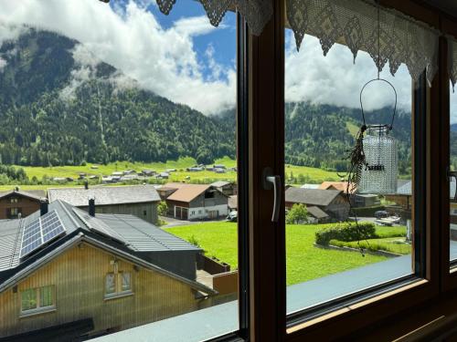 a window with a view of a mountain at Ferienwohnung Schoppernau in Schoppernau