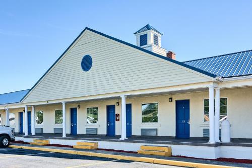 a church with blue doors on a street at Motel 6-Harrisonburg, VA - South in Harrisonburg