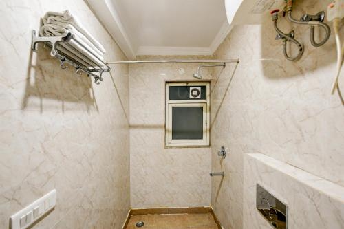 a bathroom with a shower and a window at Airport Hotel Square Plaza in New Delhi
