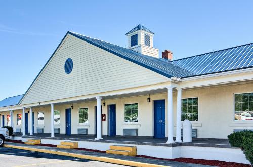 a church with blue doors on a street at Motel 6-Harrisonburg, VA - South in Harrisonburg