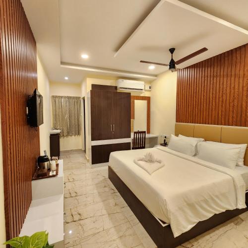 a bedroom with a large bed and a television at Hotel Dusk and Dawn in Rāmeswaram