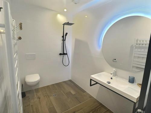 a white bathroom with a sink and a mirror at Villa ocean in Loctudy