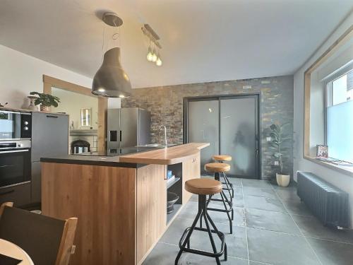 a kitchen with a counter and some stools in it at Villa ocean in Loctudy
