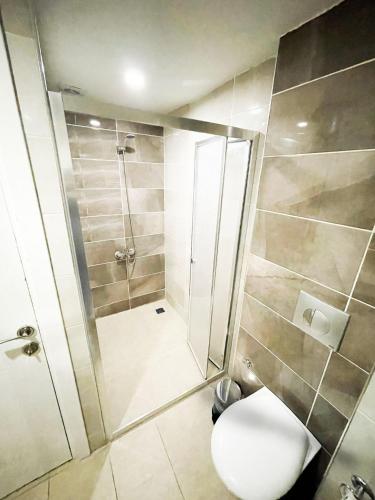 a bathroom with a shower and a toilet in it at Dnc Pansiyon in Konak