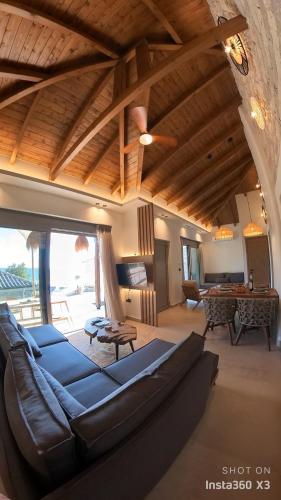 a living room with a couch and a table at Villa Vrachos luxury Living in Vrachos